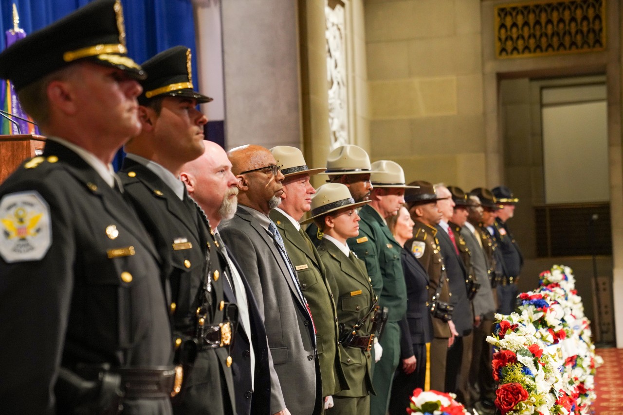 Enforcement officers stand at the Peace Officer Memorial. 