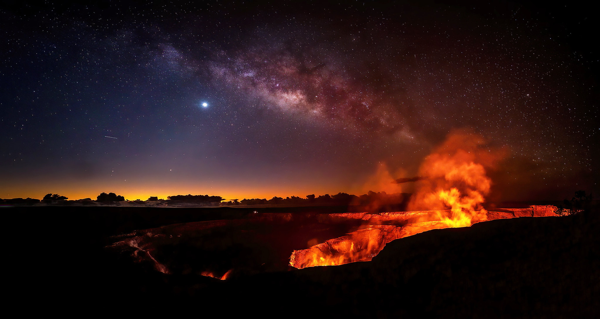 Milk way seen above Kilauea crater and orange lava lake at Hawai'i Volcanoes National Park 