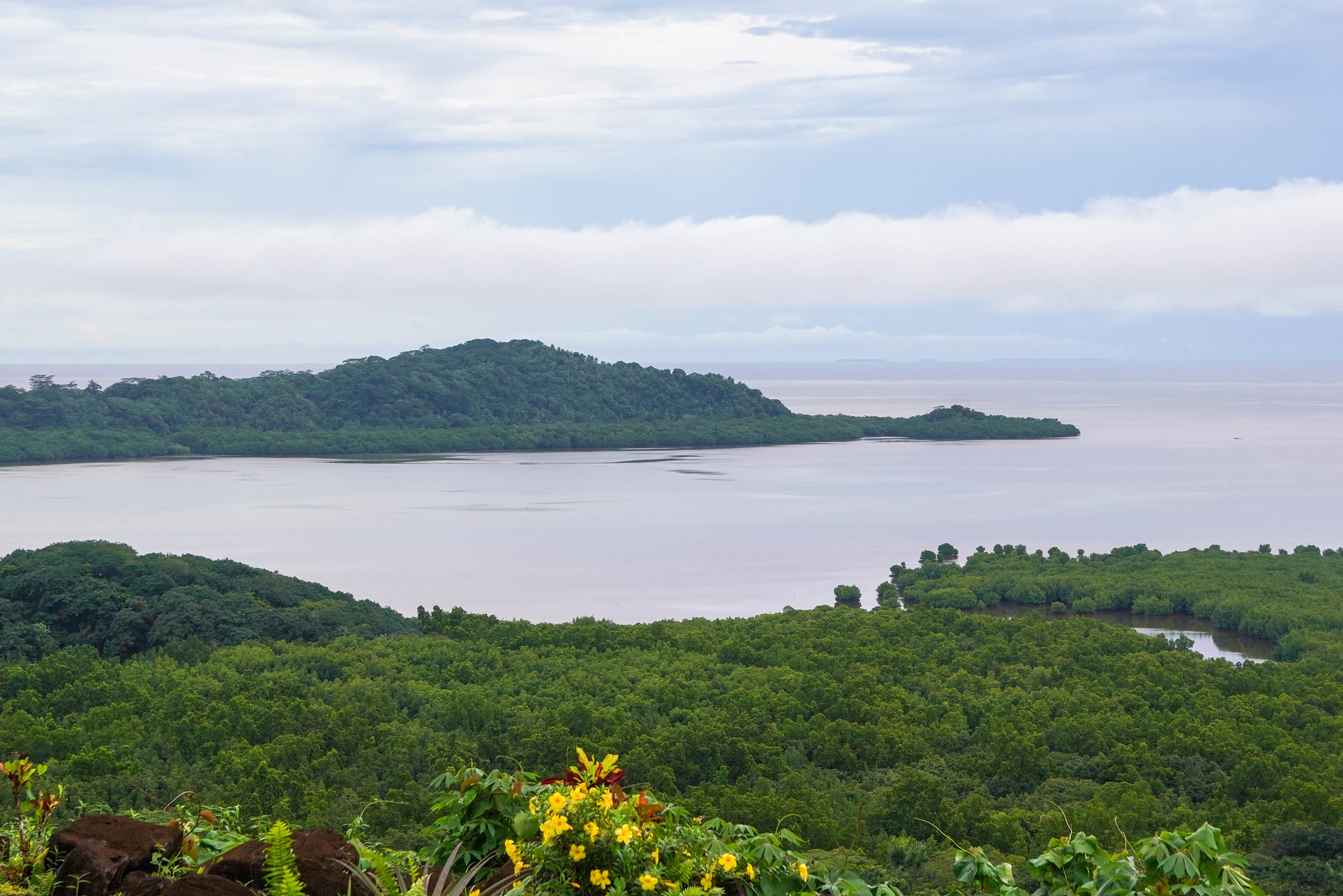 Island areas surrounded by cloudy skies. 