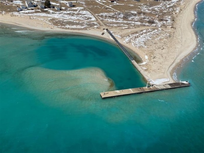  Aerial view of island dock surrounded by blue water.