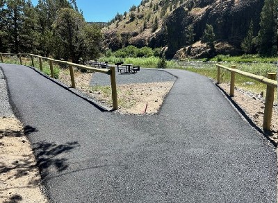 Paved path going to group site area or parking and follows the Crooked River allowing access.