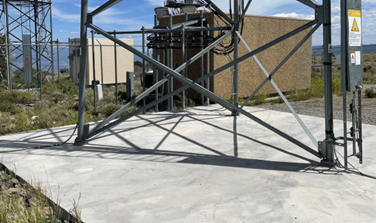Close up view of concrete base of radio tower.