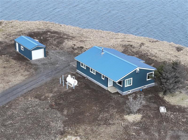  Aerial view of a residential building with a smaller matching building nearby.