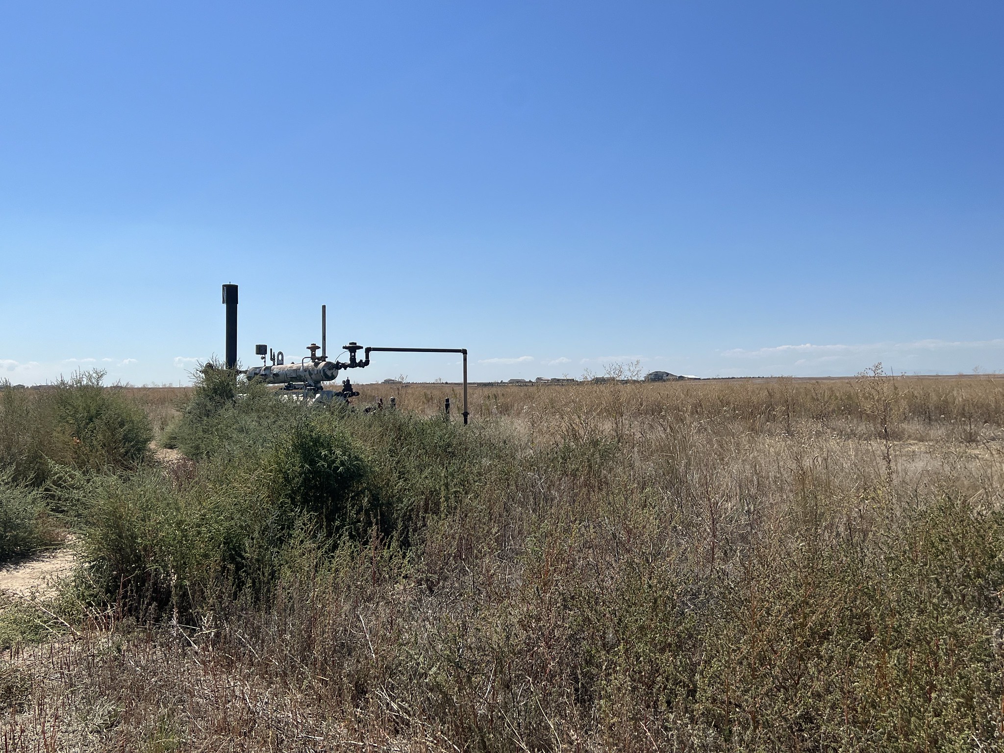 Field with orphaned well equipment.