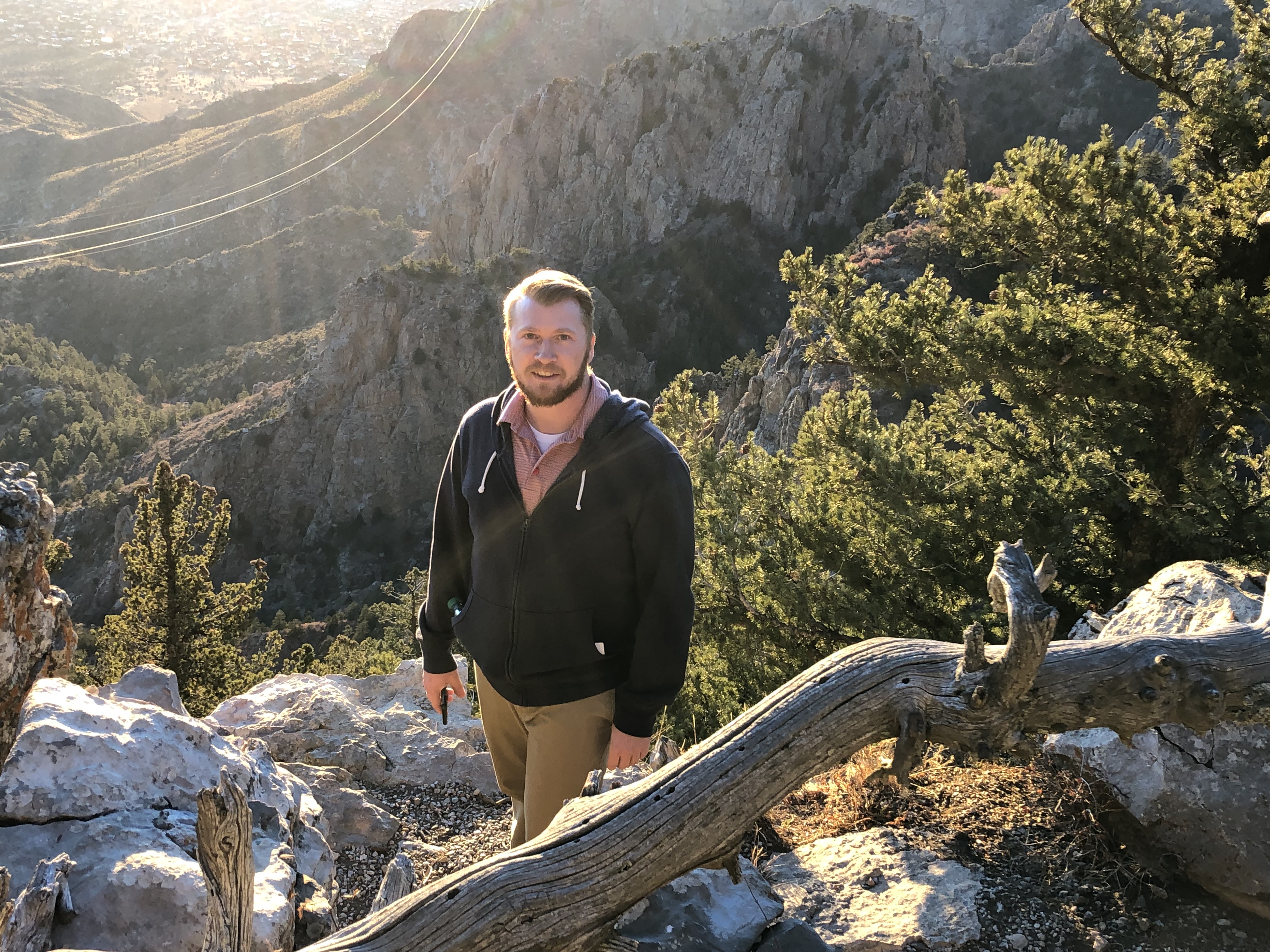 Josh standing in front of a mountain landscape.