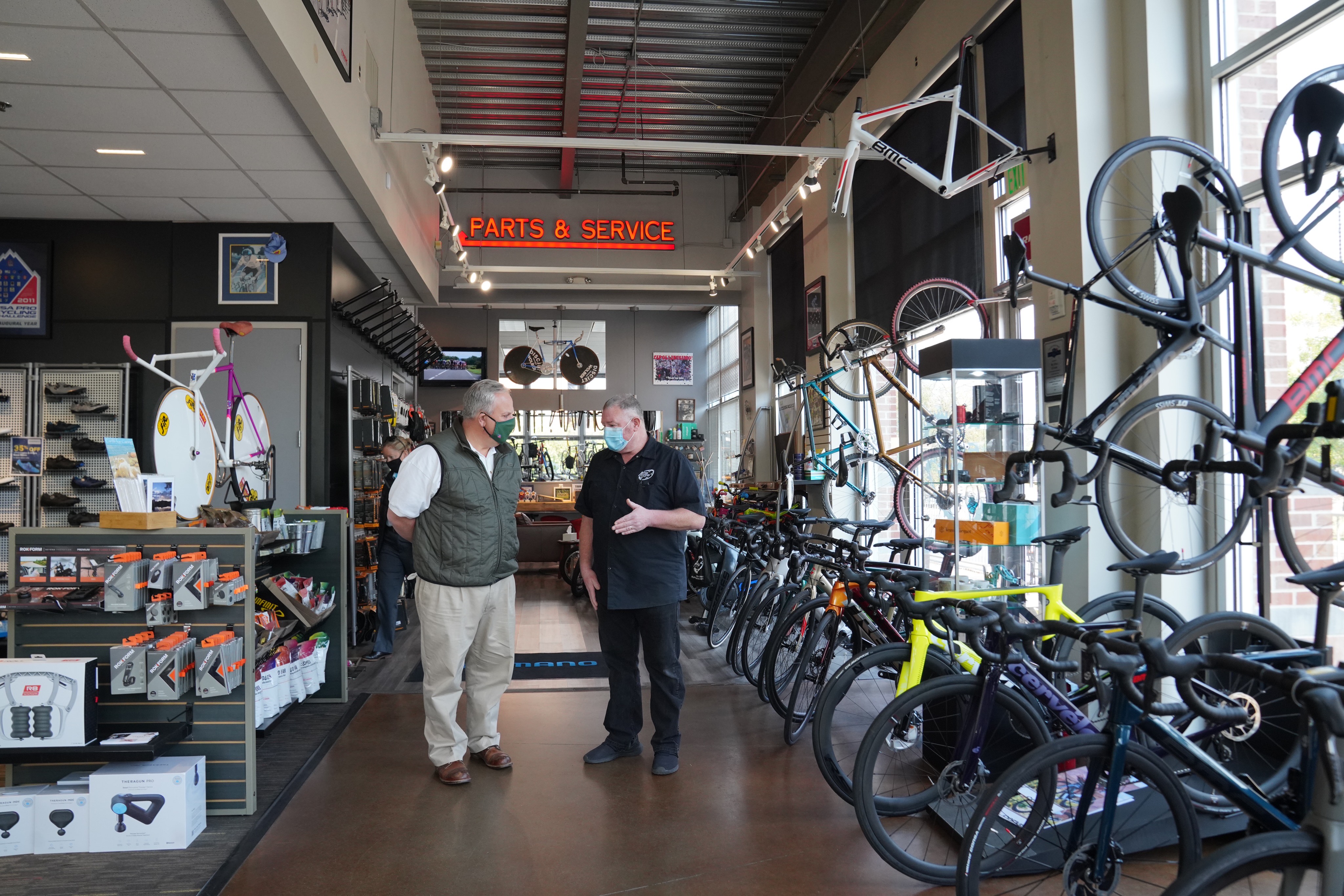 Secretary Bernhardt talks to a man in a bicycle shop.