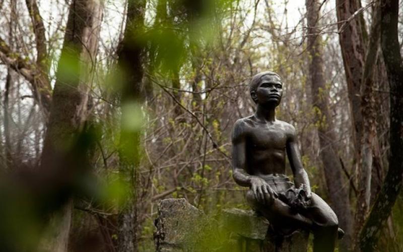 A statue of a young African American boy at the George Washington Carver Memorial.