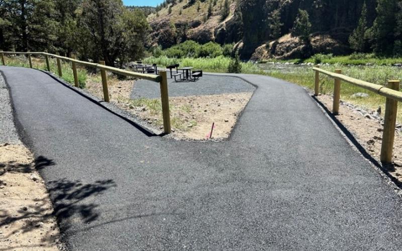 Paved path going to group site area or parking and follows the Crooked River allowing access.