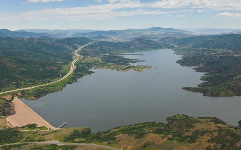 Aerial view of Jordanelle Dam and Reservoir with highway to Park City on the Left and highway to Kamas on the right.