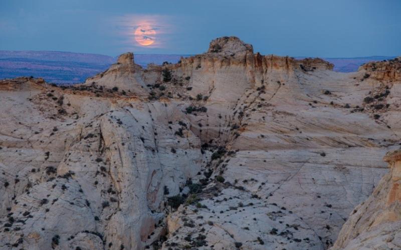Full moon behind pink clouds at Grand Staircase-Escalante.