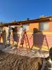 Workers remove the windows of a dormitory in the Navajo region. 
