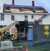 Construction crew repairs the roof of the historic George Hall House at Minute Man National Park.