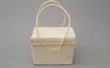 White woven bag with handles.