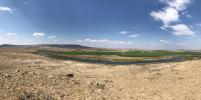 Sprawling ranchland with a river snaking through it