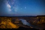 The deep canyon of the Snake River under a starry sky.