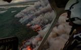 Helicopter pilot overlooks wildfire.