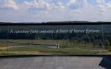 A glass monument reads, "A common field one day. A field of honor forever." 