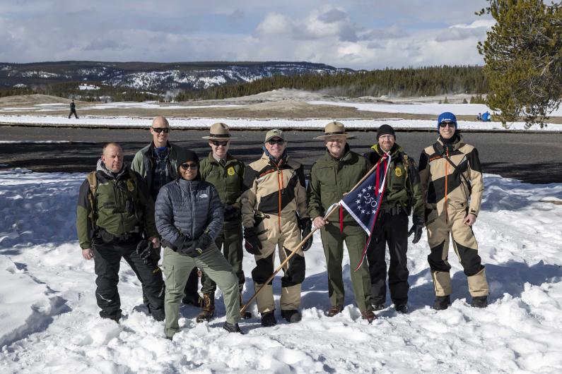 Yellowstone staff with Sec Doug Burgum holding 250 flag