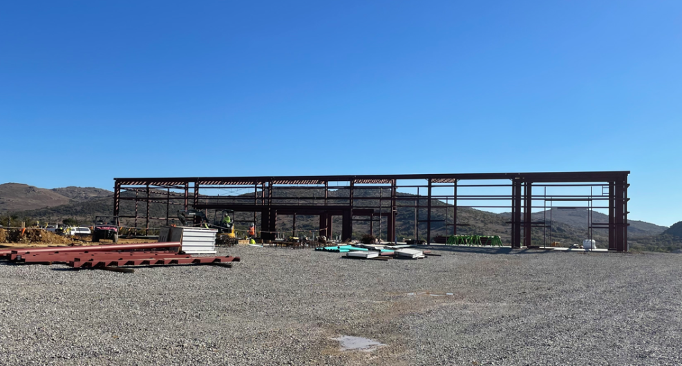 Steel frame with mountains in the background.