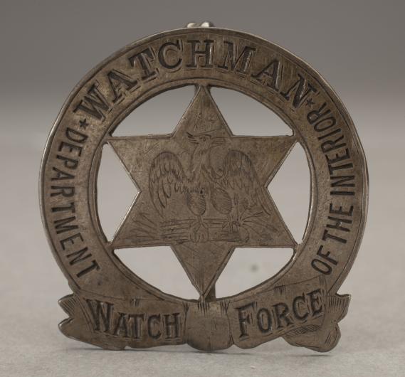 Pin-style badge with a six-pointed star, eagle, and the words, "Department of the Interior Watch Force Watchman"