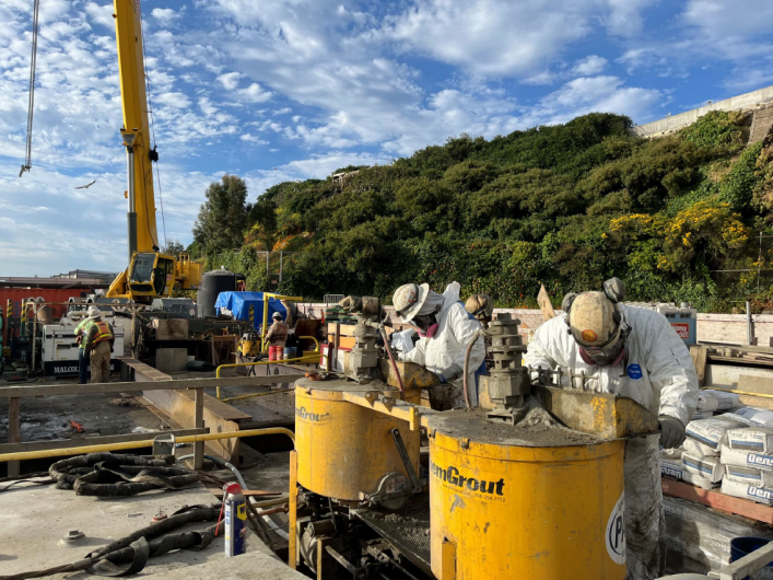 Construction workers mixing grout to support stabilization of the Alcatraz Warf.