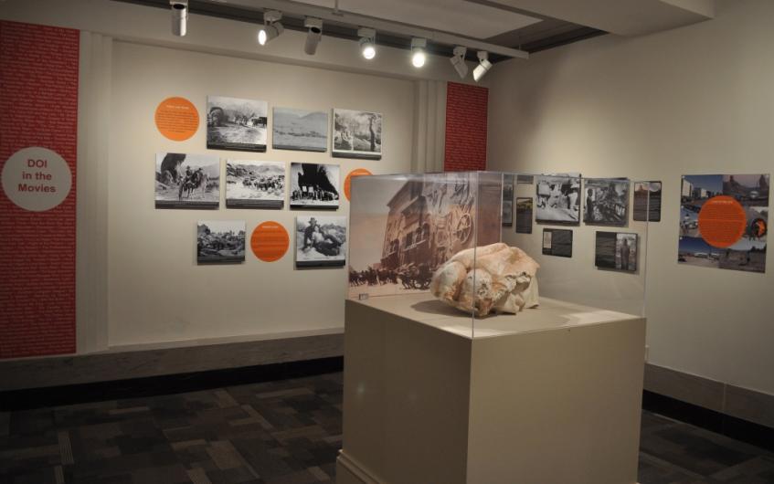 View of the "DOI Pop!" exhibition gallery and the section about the Department of the Interior in film.