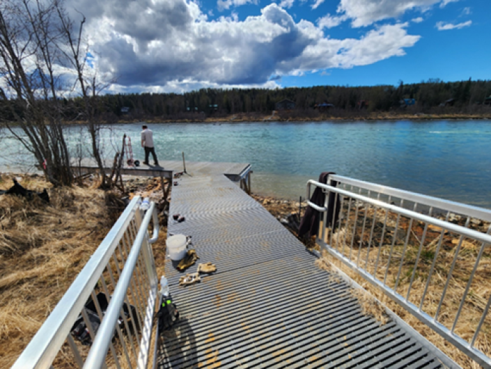 Newly restored boardwalk leads to bright blue body of water