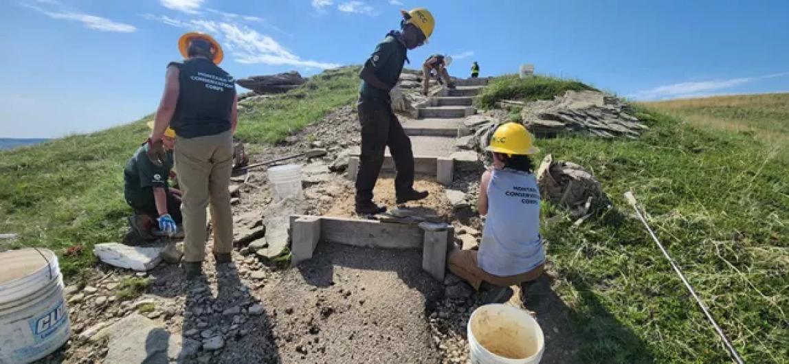 Maintenance Workers restore paved walking trail