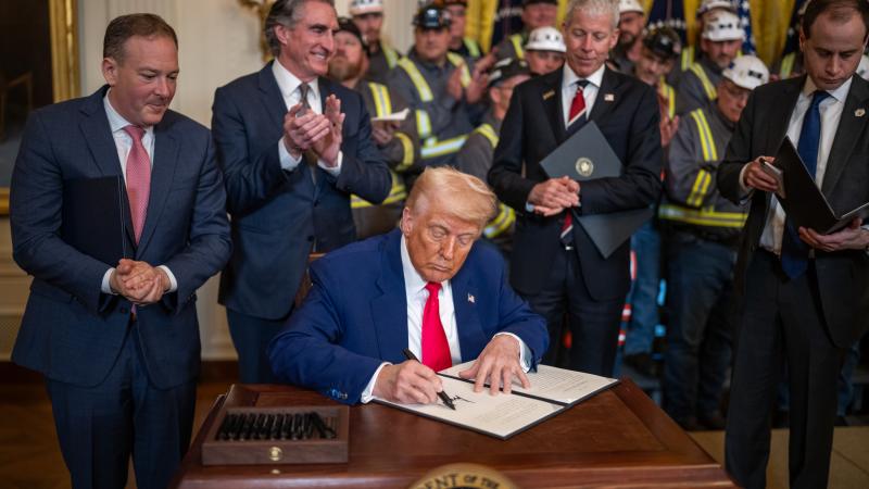 President Trump signing EO with Secretary Burgum clapping in background