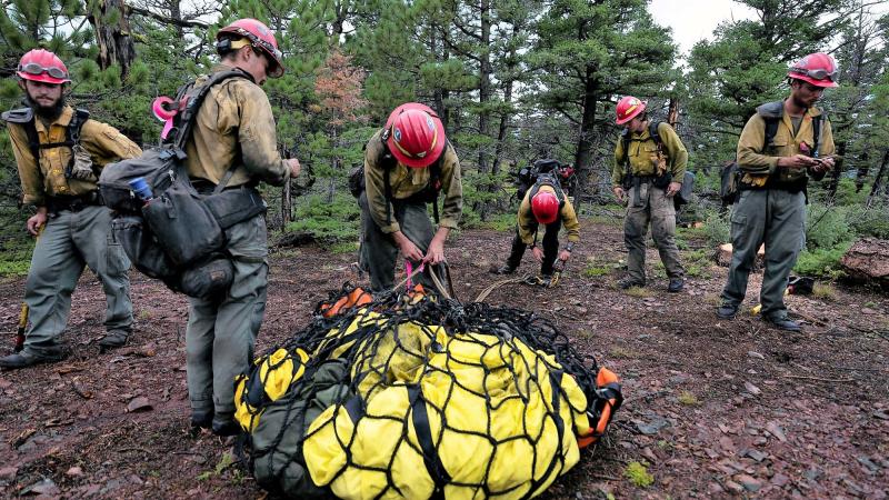  Wildland firefighters assemble a sling load of gear on a wildfire near Helena, Montana.