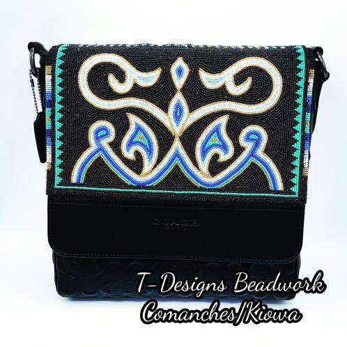 Image of a black purse with an embroidered beaded design.