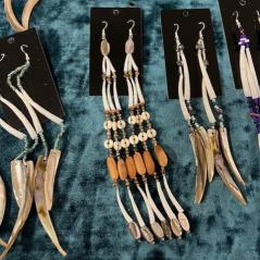 Photograph of multiple pairs of earrings made of dentalium and beads. 