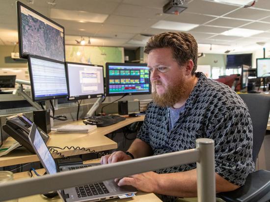 A dispatcher at the Boise Interagency Dispatch Center tracks wildfires and firefighting resources in southwestern Idaho. Photo by Neal Herbert, Department of the Interior.