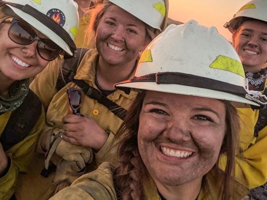 Smudged wildland firefighters smile for a selfie.