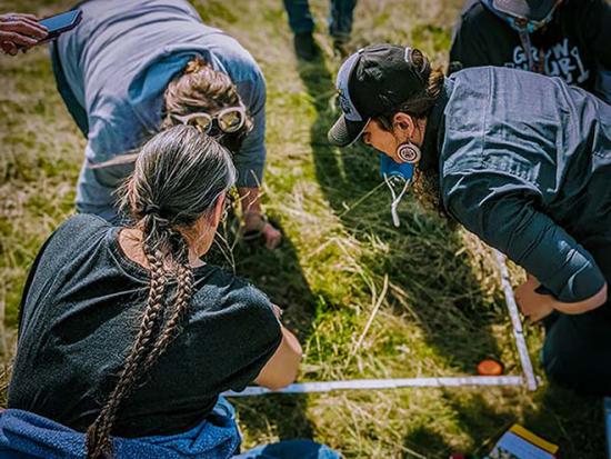 People gather at the Spokane Food Sovereign Garden to establish fire effects monitoring plots. Photo courtesy of the Spokane Tribal Network.