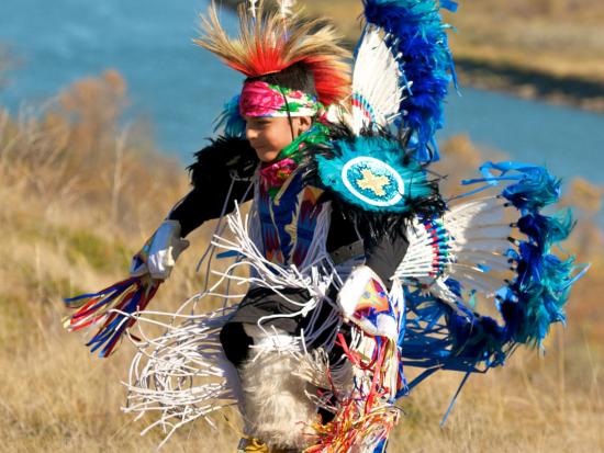 Tribal youth dancer performing a pow wow dance.