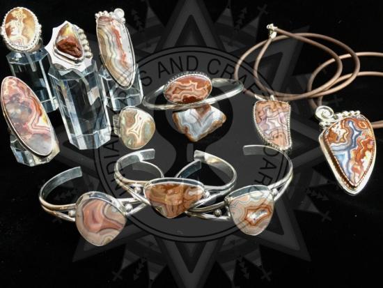 A display of silver jewelry with brown gemstones.
