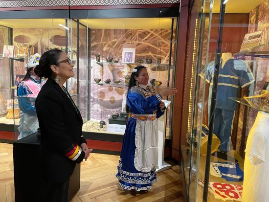 Secretary Haaland and two others look at display case in Cultural Center 