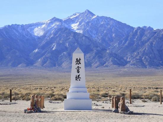 A ceremonial marker with Japanese characters at Amache National Historic Site in Colorado with mountains in the background. 