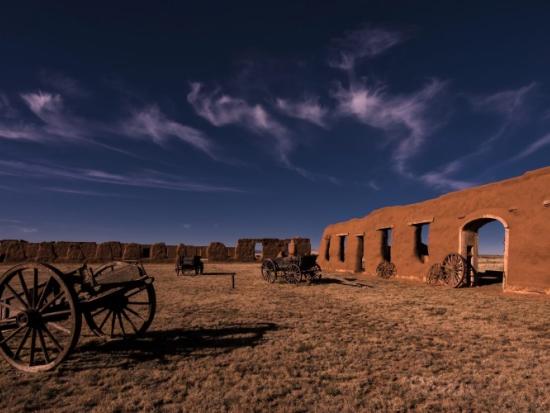 Night sky over remains of red dirt fort structure