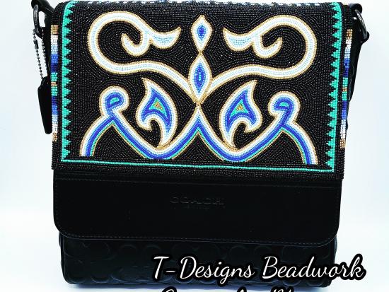 Image of a black purse with an embroidered beaded design.