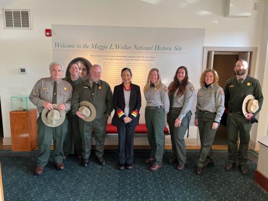 Secretary Haaland and 7 others in NPS uniform