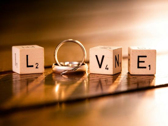 "Love" spelled with two wedding rings and three blocks