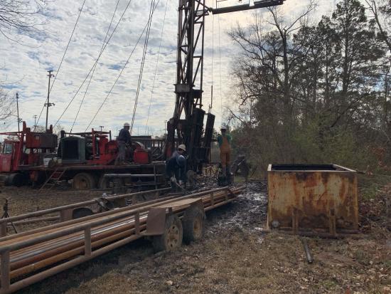 4 people in safety gear operate heavy machinery