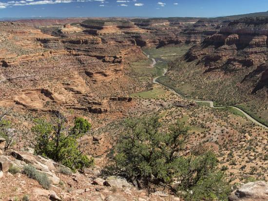 Sloping canyon walls with river running through the middle