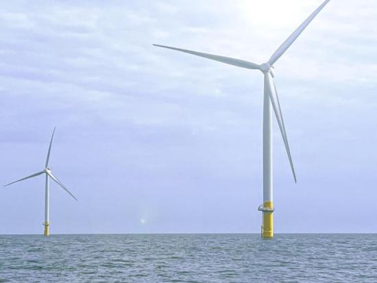Two wind turbines in ocean. 