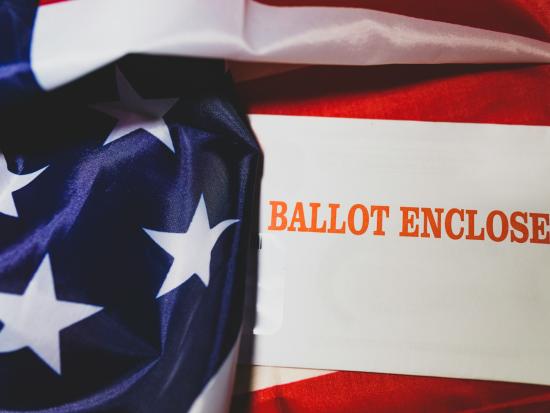 Photo of a paper ballot and American flag