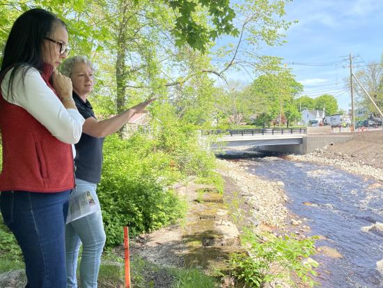Assistant Secretary for Fish and Wildlife and Parks Shannon Estenoz and another person pointing at a river. 