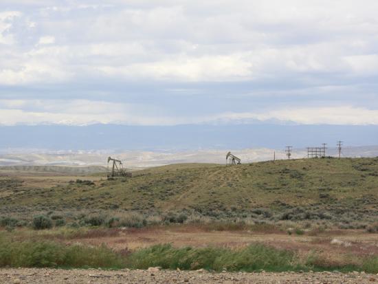 Landscape with oil rigs in distance