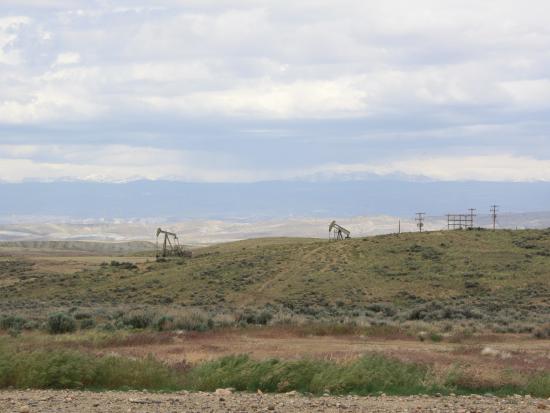 Desert landscape with oil rigs. 